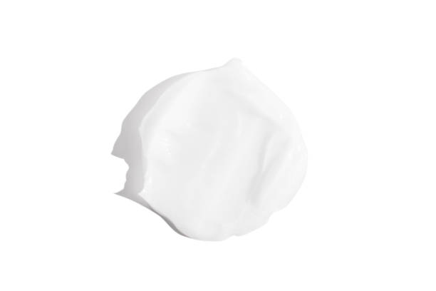 istock A smear of white cream on a white background. 1491211471