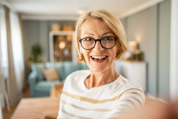 istock Caucasian mature woman taking selfie or having video call using mobile phone 1491212033
