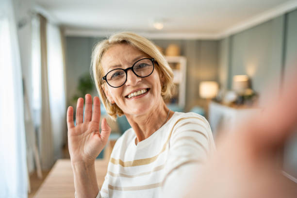 istock Caucasian mature woman taking selfie or having video call using mobile phone 1491212039