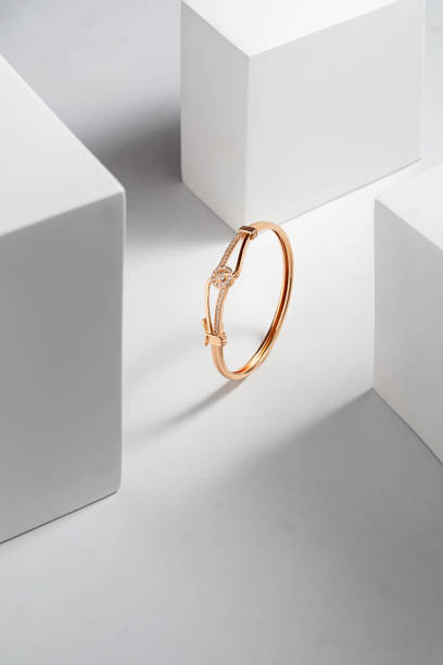 istock Top view of golden bracelet on white dramatic background with copy space 1491214495