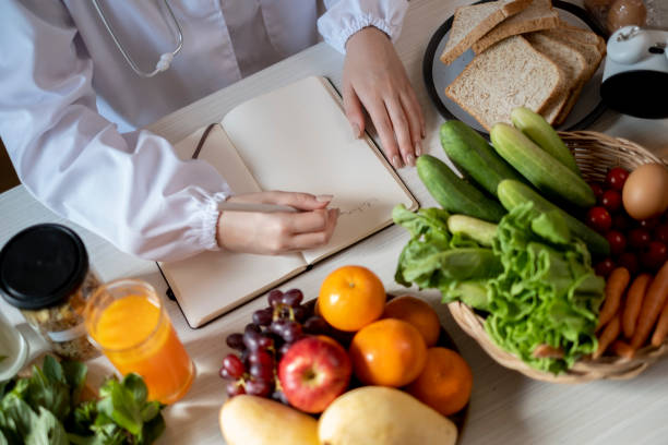 istock Nutrition consulting with note book and vetgetable background. 1491218744