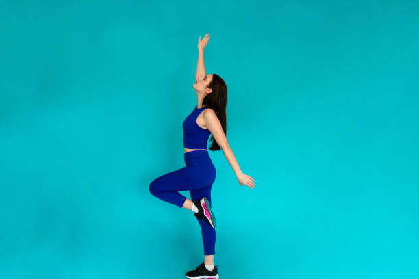 istock Woman jumping in the air in studio shot. 1491218887