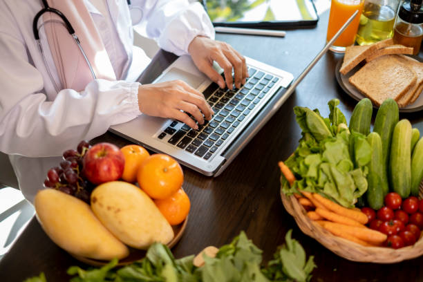 istock Top view of nutrition consulting suing laptop on table. 1491218908