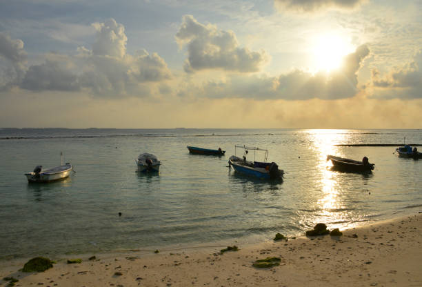 Villingili / Vilimalé Island, Kaafu / North Malé Atoll, Maldives: boats and late afternoon sun on Villingili beach, on the south-west coast.
