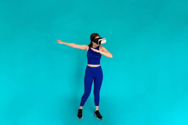 istock Woman with vr glasses simulating using bow and arrow. 1491220546