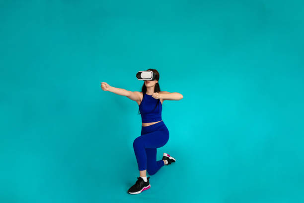 istock Woman with vr glasses simulating using bow and arrow. 1491220684