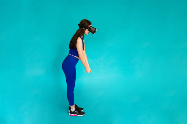 istock Woman in studio simulating golf on vr glasses. 1491221302