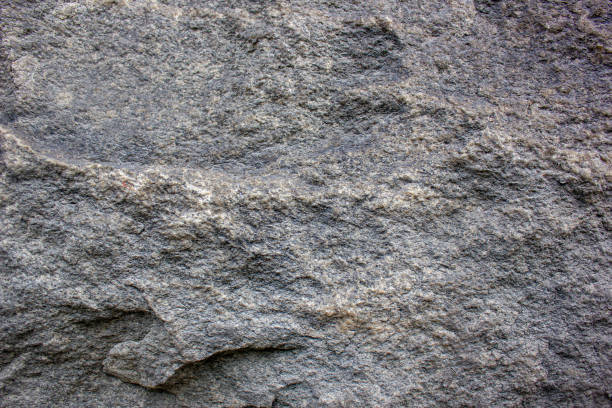 istock Dark authentic granite.Granite stone,texture,design.Granite facade,rough surface,detail background. 1491221572