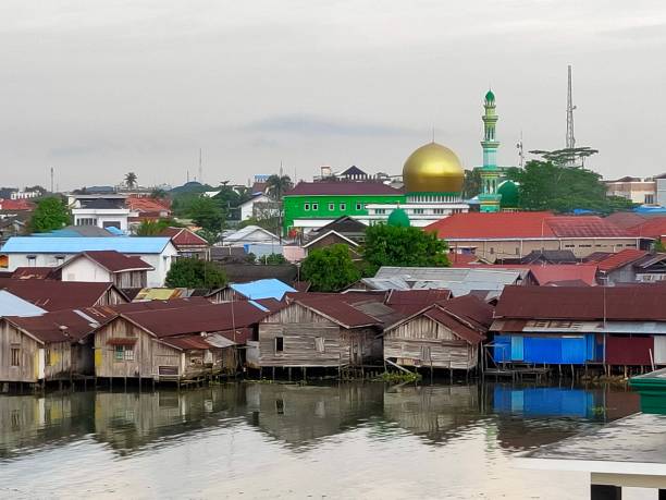 houses on riverside with mosque