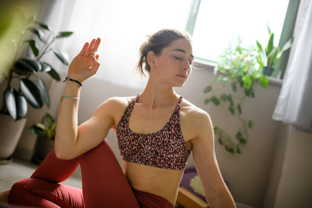 istock Woman practicing yoga at home 1491224142