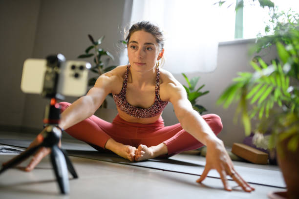 istock Woman practicing yoga at home, online lesson 1491224329