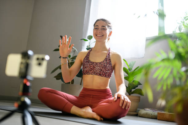 istock Woman practicing yoga at home, online lesson 1491224481