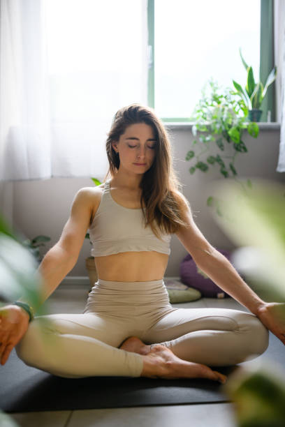 istock Woman practicing yoga at home 1491224744