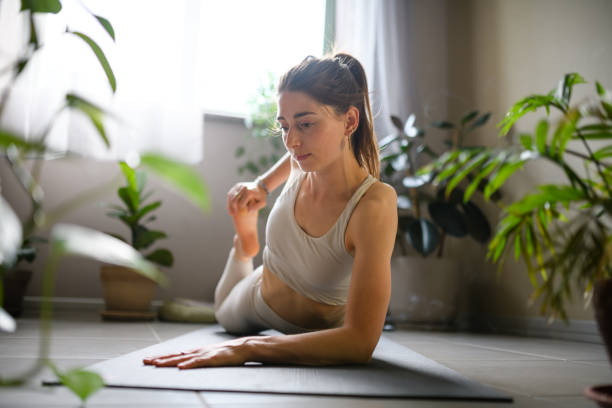 istock Woman practicing yoga at home 1491224983