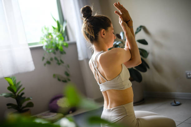 istock Woman practicing yoga at home 1491225177