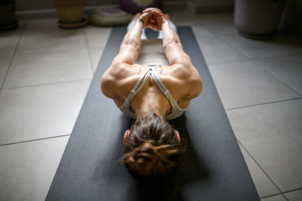 istock Woman practicing yoga at home 1491225277