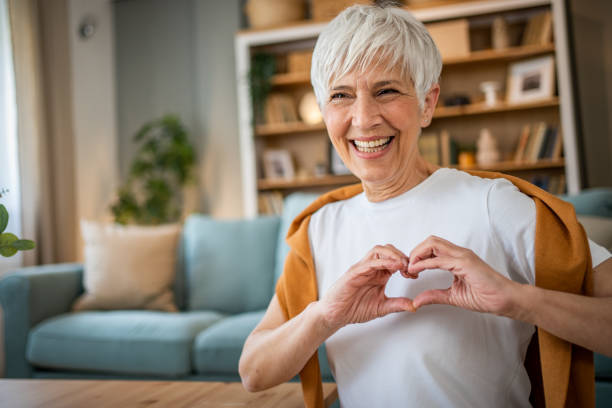 istock Happy elderly woman making a heart sign with her hands 1491228906