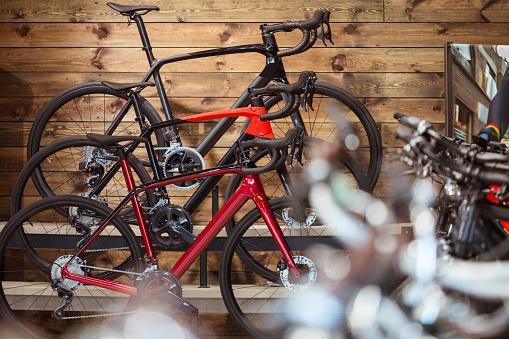 Bikes standing in bicycle shop. Focus on racing bicycles.