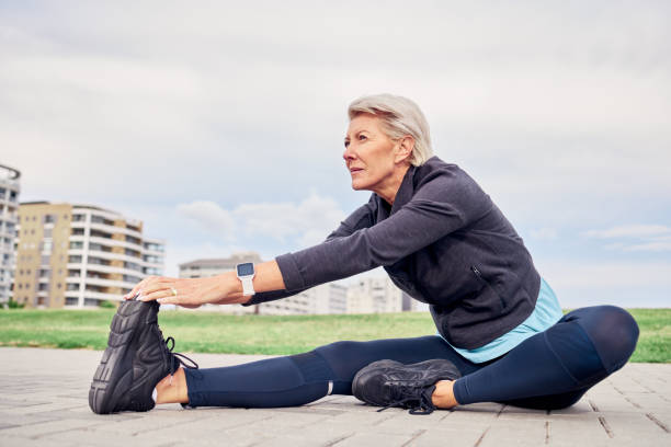 femme, exercice d’étirement et sports sur maquette du ciel, terrain de parc et motivation d’entraînement à miami. les femmes âgées échauffent les jambes à l’extérieur pour l’entraînement, la forme physique et la pensée d’un état d’es - senior adult outdoors wellbeing sky photos et images de collection