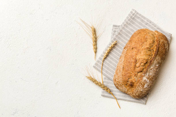 istock Fresh Homemade Whole Wheat Bread. bread on napkin on rustic background, fresh bread top view 1491233008