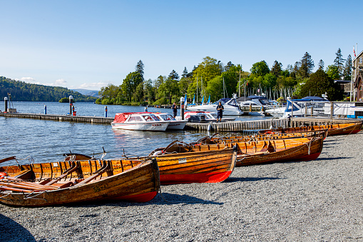 Yachts and boats moored in Lake Windermere , blue skies, tranquil scenery, picturesque post card scene