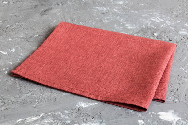 istock top view with red empty kitchen napkin isolated on table background. Folded cloth for mockup with copy space, Flat lay. Minimal style 1491233215