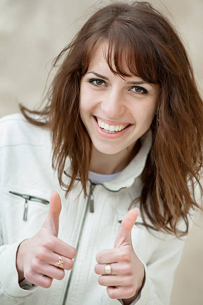 Monochrome dressed young woman laughing on open air