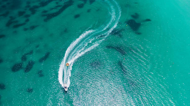 istock Aerial view on motorboat and jetski on the sea surface. 1491235877
