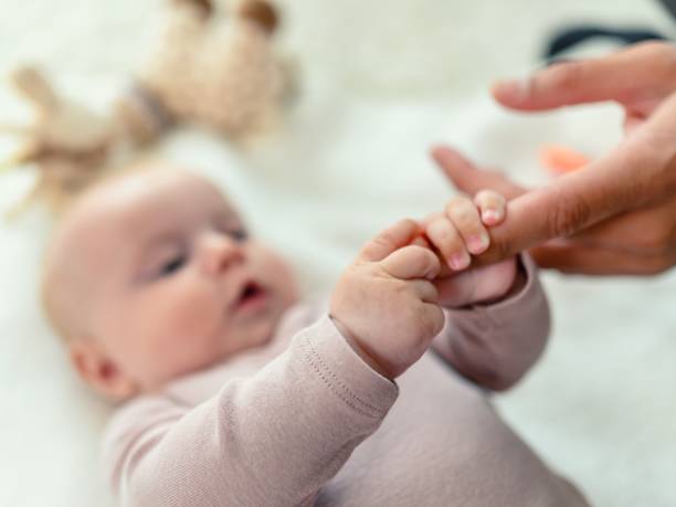 istock Hand holding newborn baby's hand 1491241481