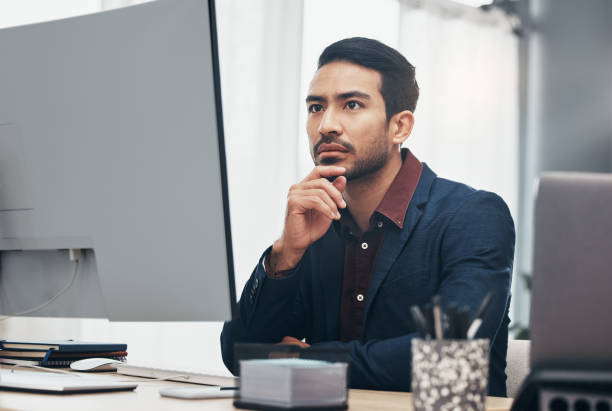 istock Business, concentration and man at computer thinking or brainstorming ideas for online project. Planning, analytics and Indian businessman, internet search for startup idea sitting at desk in office. 1491242677