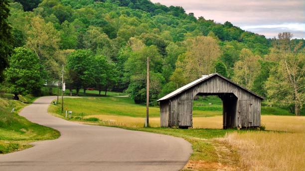 istock one brown and empty wooden barn sits beside a curvy ohio backroad. 1491244107