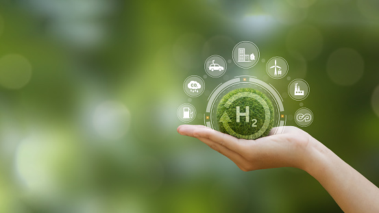 Hand of human holding green earth with the icon of H2 for Clean hydrogen energy concept.Environment, eco friendly industry and alternative energy. net zero target. Reducing greenhouse gas emissions.
