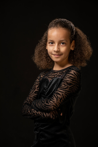 Beautiful young black girl posing for studio portrait