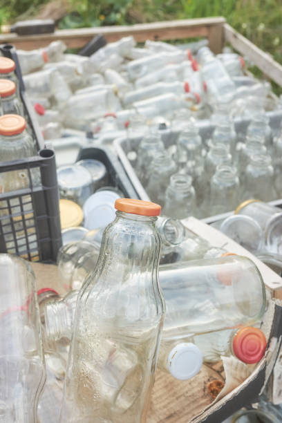 istock Various various types of empty glass bottles stored in containers for recycling. 1491247534