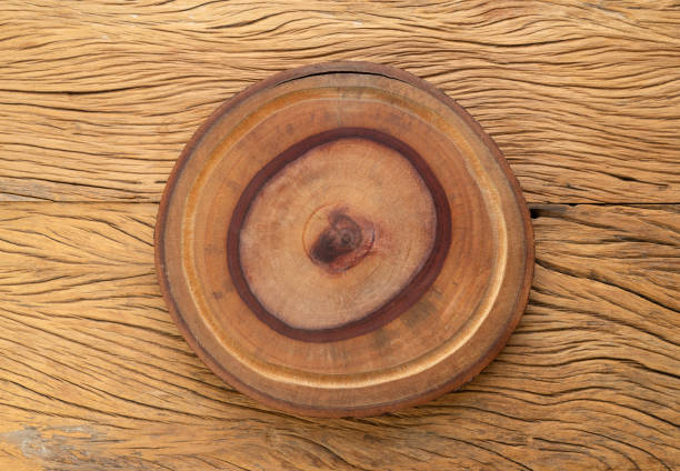 Empty rustic wooden board over wooden table with copy space.