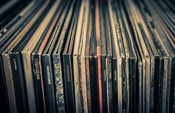 vintage vinyl record on grunge background, retro toned. - pile of newspapers audio imagens e fotografias de stock