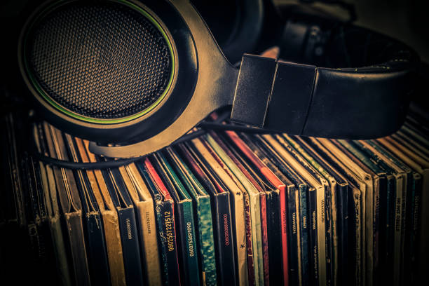 old audio books and headphones on grunge background. toned. - pile of newspapers audio imagens e fotografias de stock