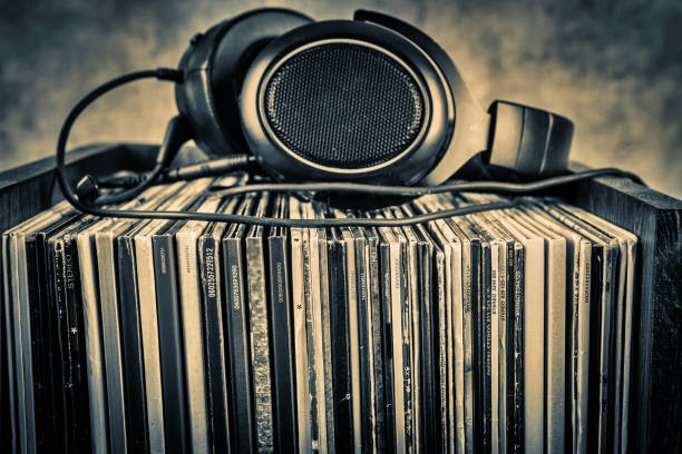 old audio books and headphones on grunge background. toned. - pile of newspapers audio imagens e fotografias de stock