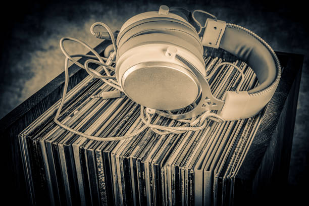 old audio books and headphones on grunge background. toned. - pile of newspapers audio imagens e fotografias de stock