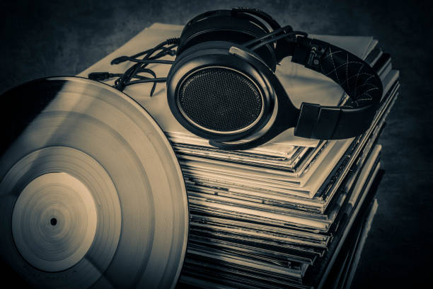 old audio books and headphones on grunge background. toned. - pile of newspapers audio imagens e fotografias de stock