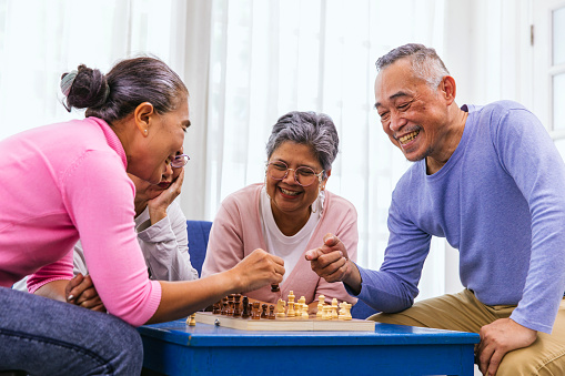 Person playing chess board game. Older Man playing chess. Hand of Senior man moving chess in success play. strategy, Management or leadership concept. concept of business strategy and tactic