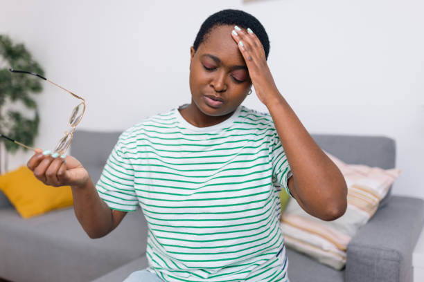 istock A young woman holding hand on forehead, suffering from headache 1491257251