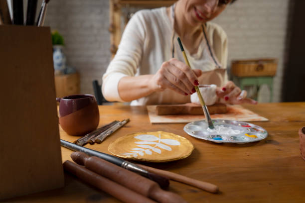 istock Woman painting a pottery 1491258530