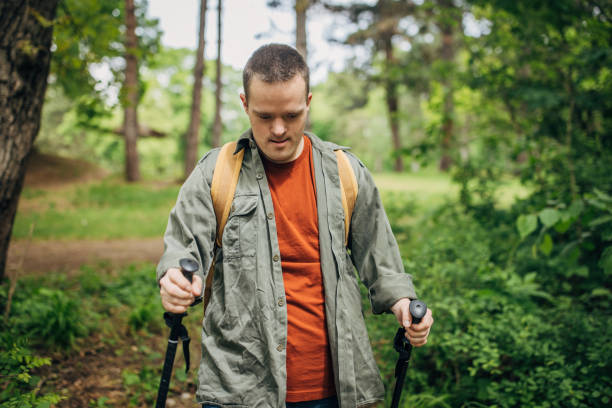 istock Young man with Down syndrome hiking in the forest 1491259720