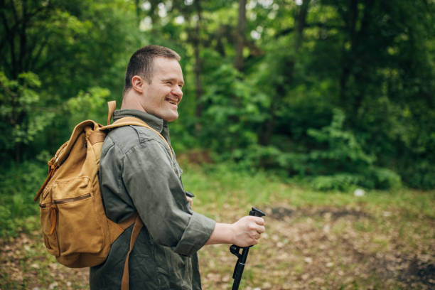 istock Young man with Down syndrome hiking in the forest 1491259903
