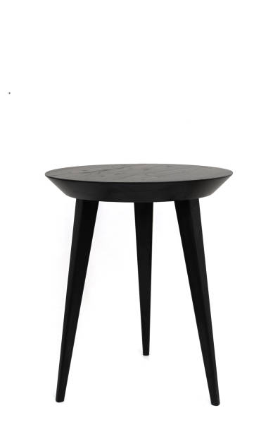 istock Round black wooden coffee table on three legs with a beautiful wood texture. Isolated on a white background 1491262109