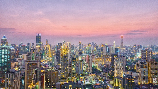 Beautiful aerial panoramic view of Bangkok cityscape at dusk during twilight time with illuminated lights from exterior of building in Central Business District of Bangkok