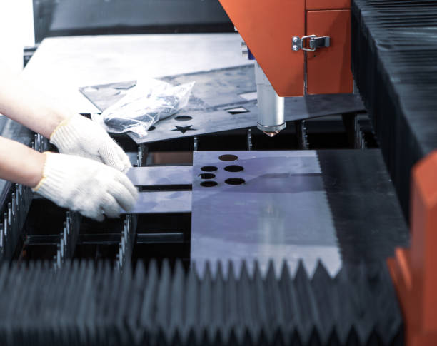 istock Worker operates CNC fiber laser cutting machine. 1491266655
