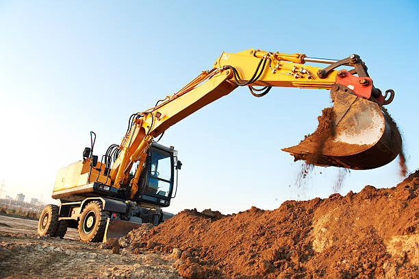 rad-lader excavator - graben körperliche aktivität stock-fotos und bilder