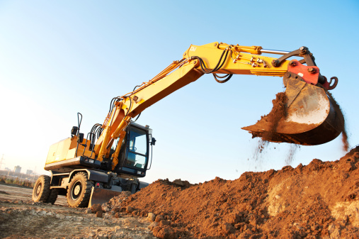 wheel loader excavator machine loading doing earthmoving work at sand quarry